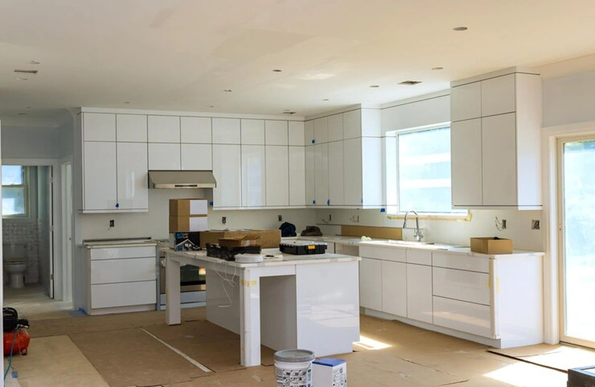 A beautiful kitchen remodel in Austin, TX, incorporating bold, custom teal accents and contemporary white cabinetry, bringing a unique and modern touch to this cooking space.
