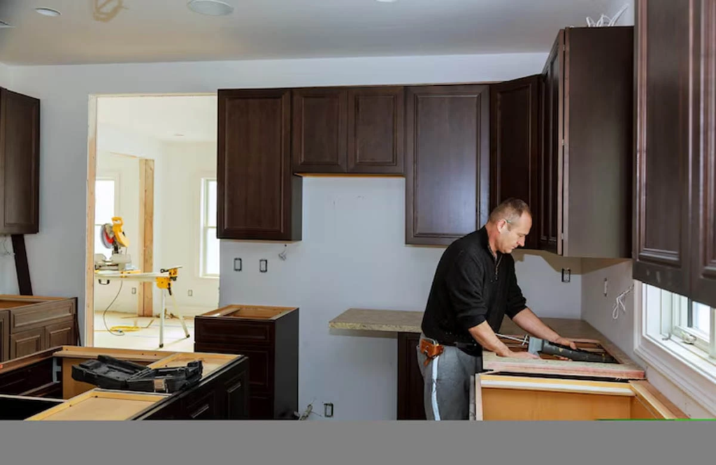 Expert home remodeling contractors in Austin upgrading kitchen cabinetry with precision, enhancing both function and elegance in this modern renovation.
