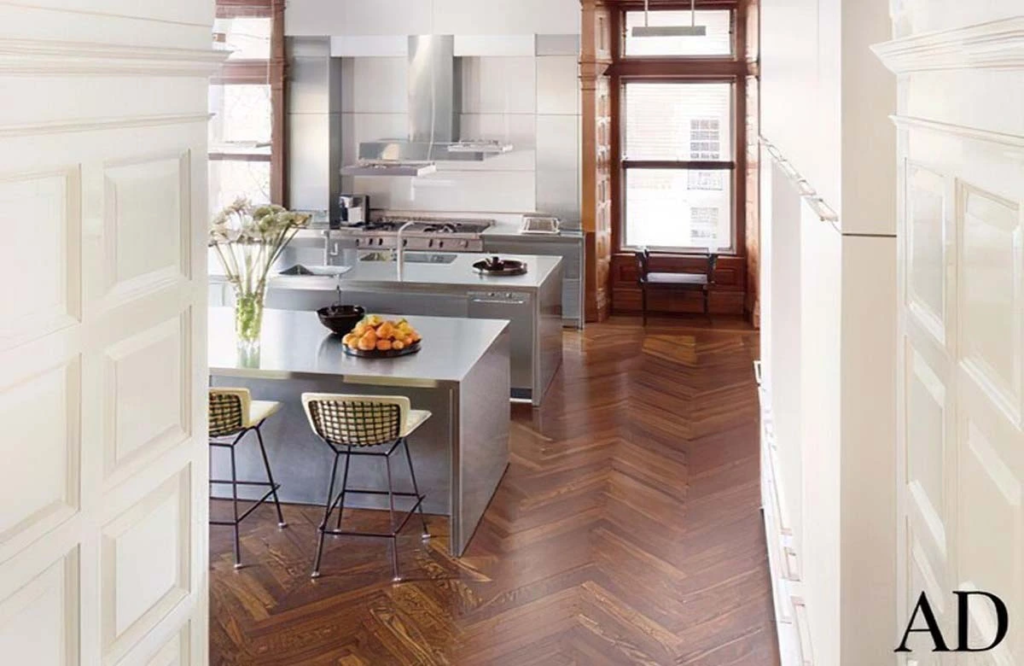 This luxurious kitchen remodeling in Austin blends modern stainless steel finishes with classic wood flooring for a sophisticated, high-end look.